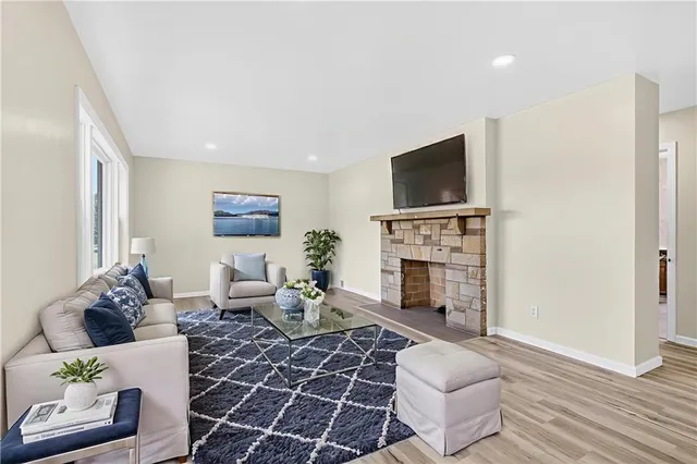 a living room with furniture a fireplace and a flat screen tv