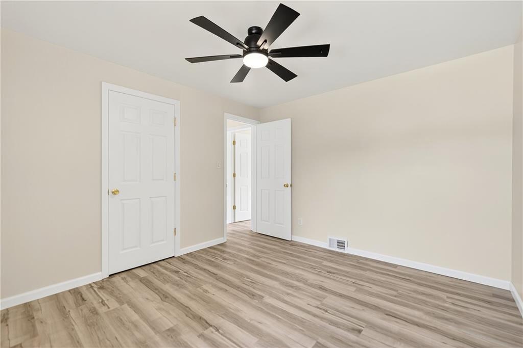 545 Vanderbilt Road Connellsville, PA 15425 - Photo 16 of 49 an empty room with wooden floor and ceiling fan