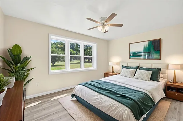 a bedroom with a large bed and a window