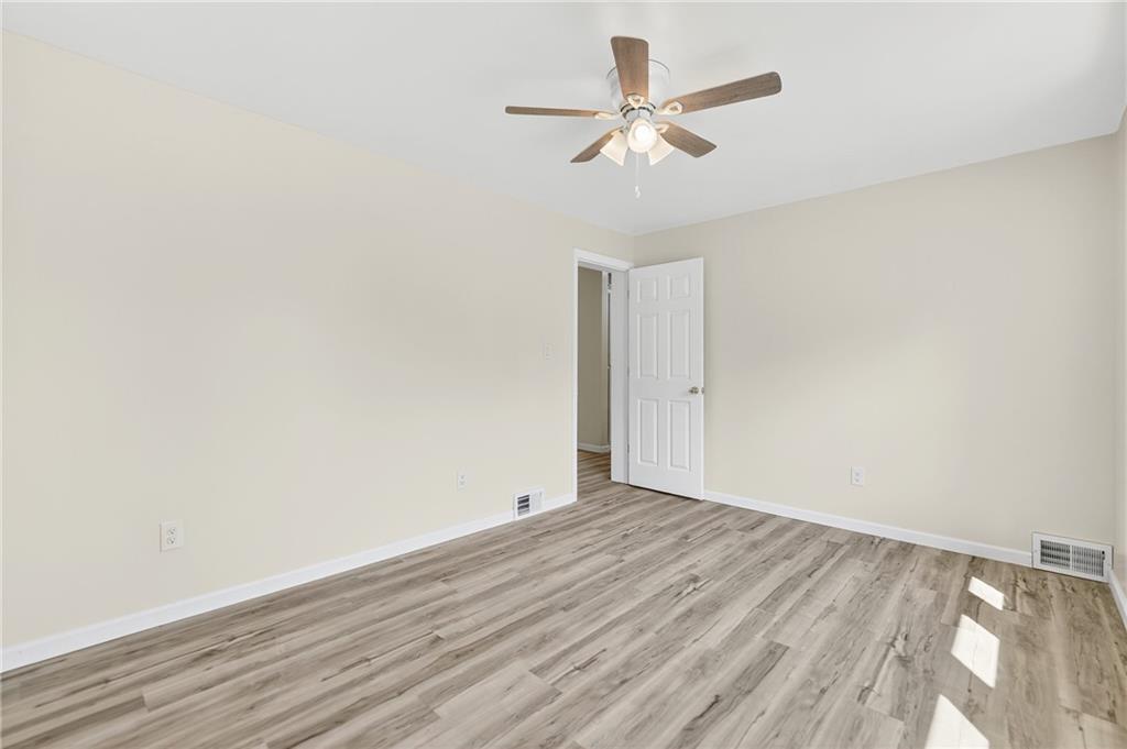 545 Vanderbilt Road Connellsville, PA 15425 - Photo 19 of 49 an empty room with wooden floor and ceiling fan