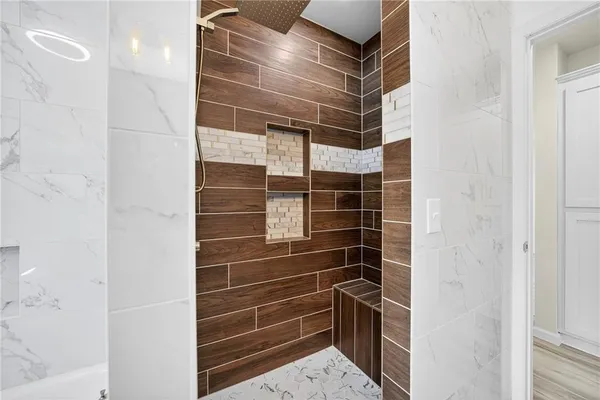 a bathroom with a glass door shower