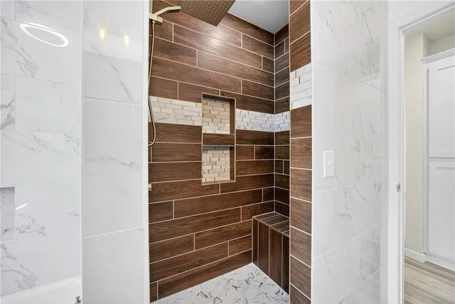 a bathroom with a glass door shower