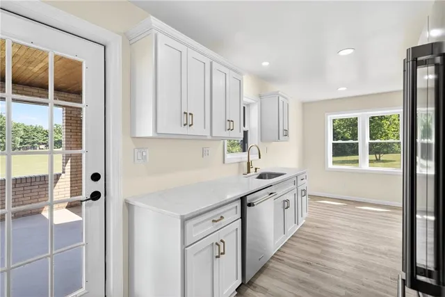a kitchen with a sink window and cabinets