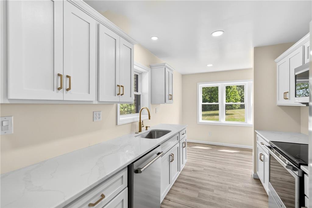 545 Vanderbilt Road Connellsville, PA 15425 - Photo 27 of 49 a kitchen with stainless steel appliances a sink stove and cabinets