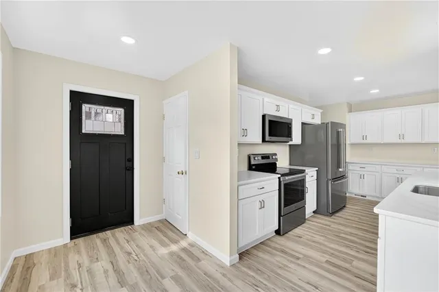 a kitchen with a refrigerator stove and oven