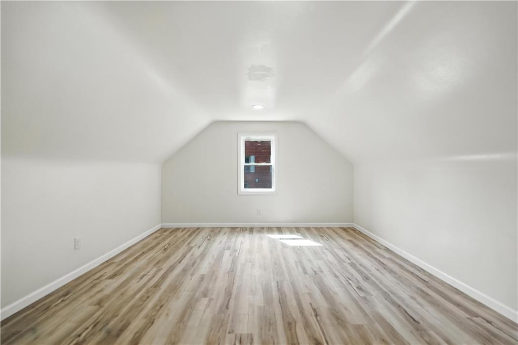 545 Vanderbilt Road Connellsville, PA 15425 - Photo 33 of 49 a view of an empty room with wooden floor and a window