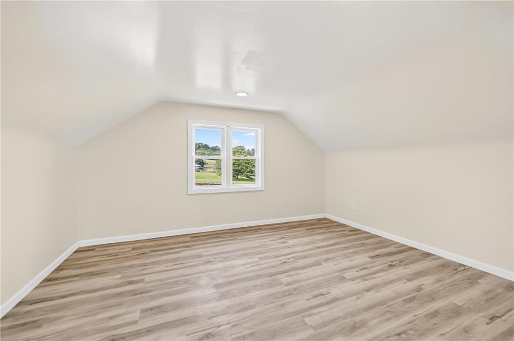 545 Vanderbilt Road Connellsville, PA 15425 - Photo 35 of 49 an empty room with wooden floor and windows