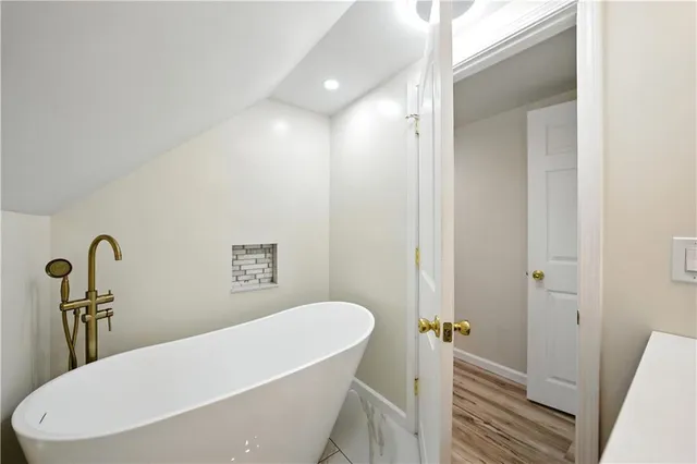 a bathroom with a bathtub and shower