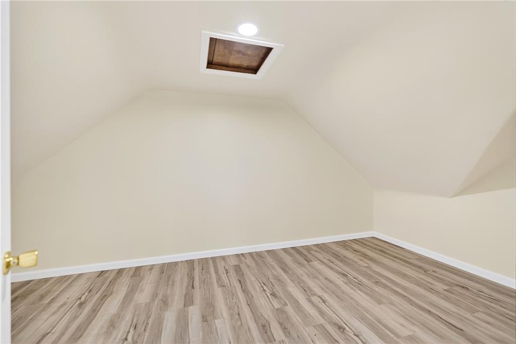 545 Vanderbilt Road Connellsville, PA 15425 - Photo 40 of 49 a view of an empty room with wooden floor and a window