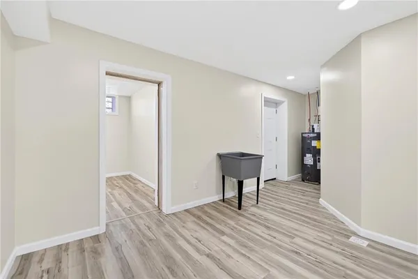 a view of a livingroom with wooden floor and a bench