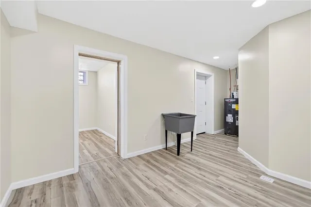 a view of a livingroom with wooden floor and a bench