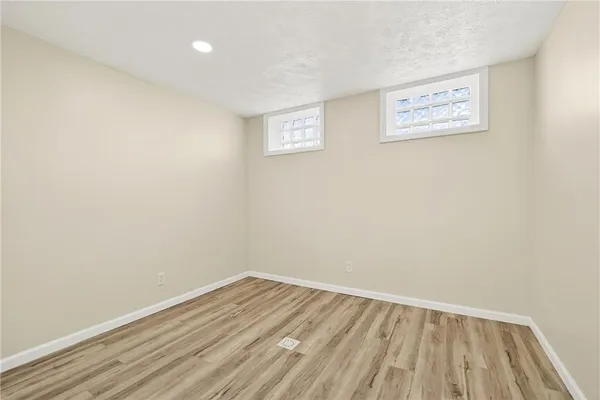 a view of a room with wooden floor
