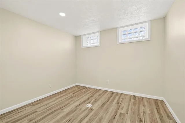 a view of a room with wooden floor