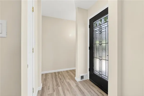 a view of front door with wooden floor
