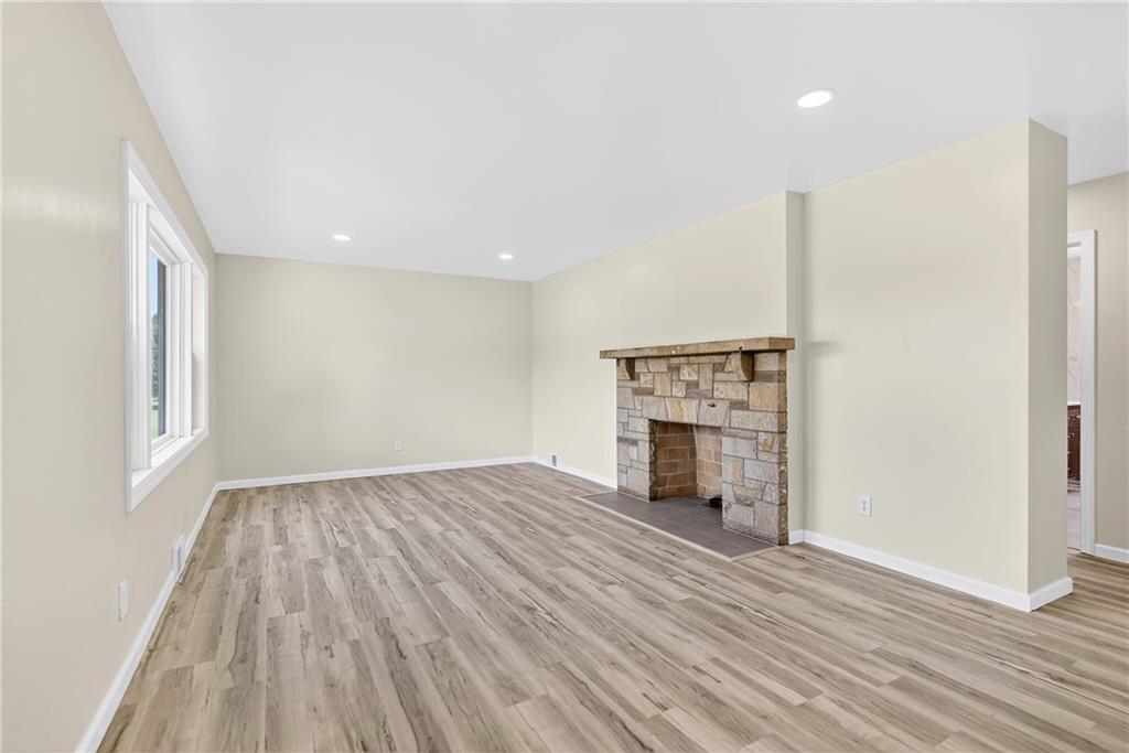 545 Vanderbilt Road Connellsville, PA 15425 - Photo 10 of 49 an empty room with wooden floor fireplace and windows