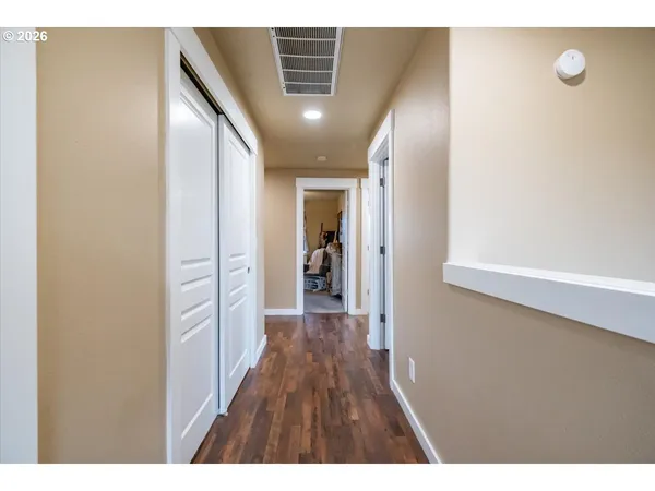 a view of hallway with wooden floor