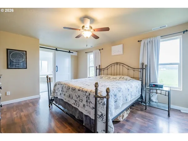a bedroom with a bed a chandelier and a window