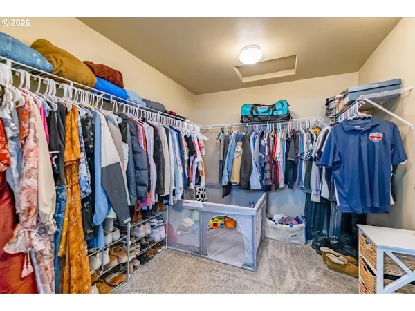 a view of walk in closet with clothes