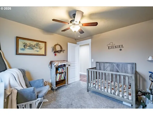 a bedroom with furniture and a baby crib