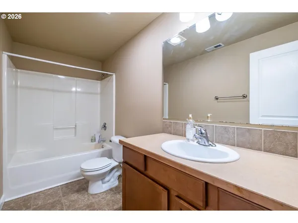 a bathroom with a sink toilet a mirror and shower