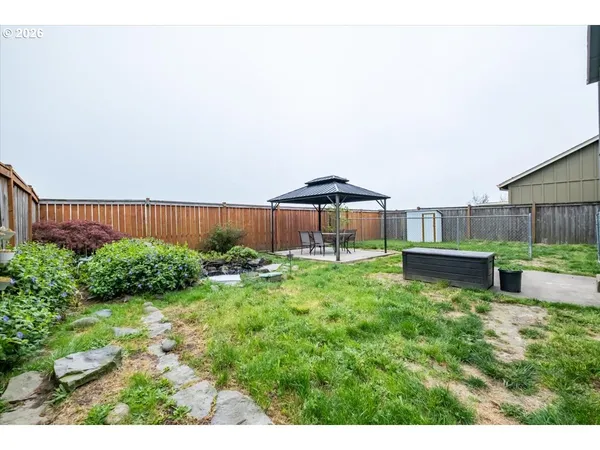 a view of a house with a yard and sitting area