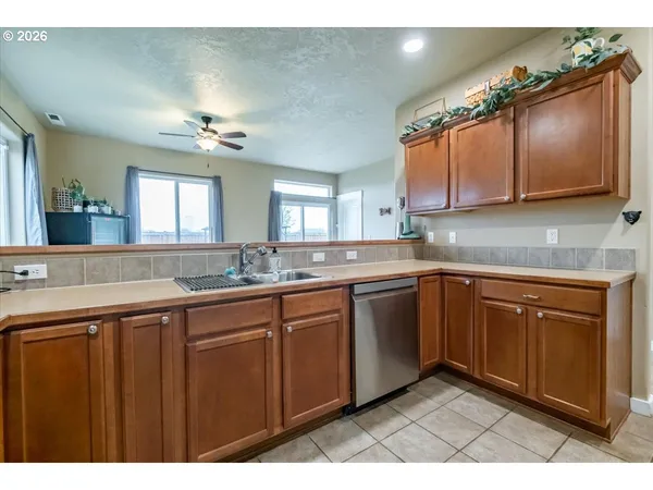a kitchen with a sink cabinets and window