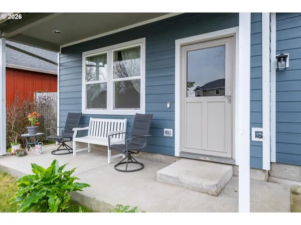 a view of porch with a bench and dining table