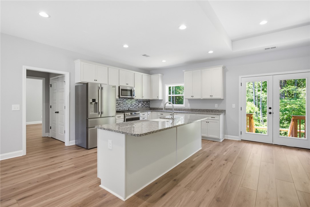 912 Watercrest Road West Union, SC 29696 - Photo 9 of 49 This spacious kitchen offers a central island, stainless steel appliances, and abundant natural light.