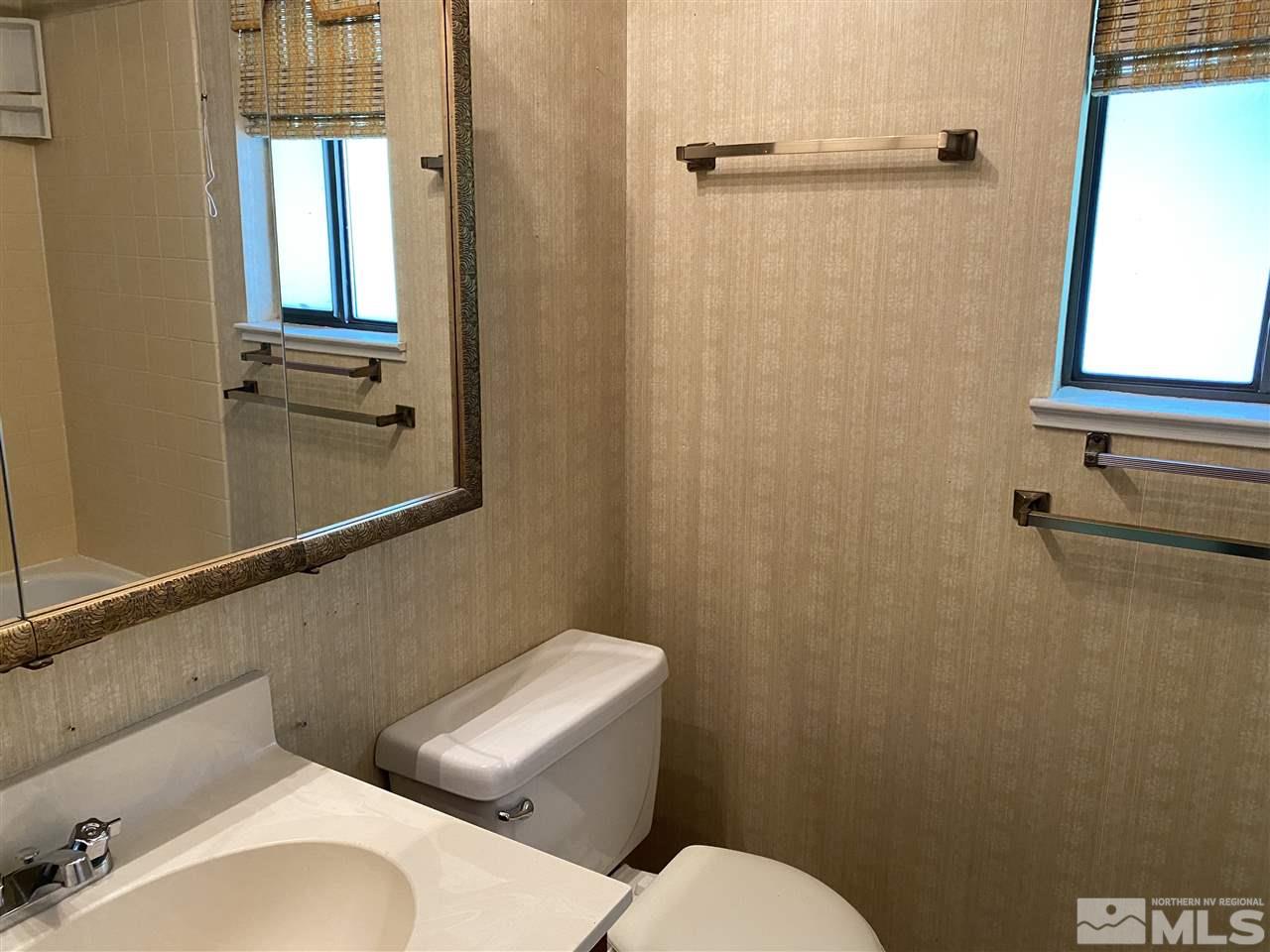 1207 Searchlite Court Reno, NV 89503 - Photo 13 of 17 a white toilet sitting next to a bathroom sink
