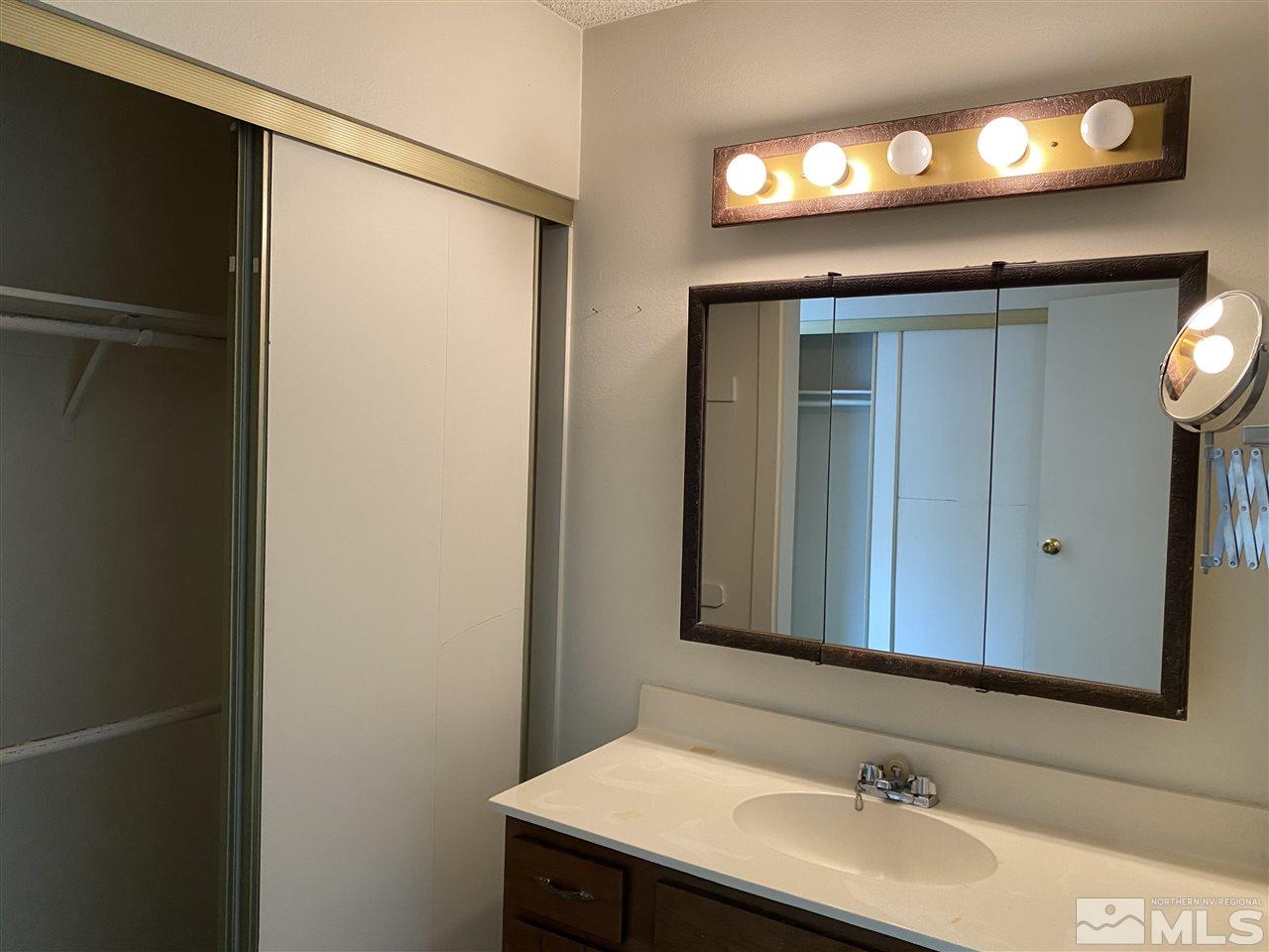 1207 Searchlite Court Reno, NV 89503 - Photo 15 of 17 a bathroom with a sink and a mirror