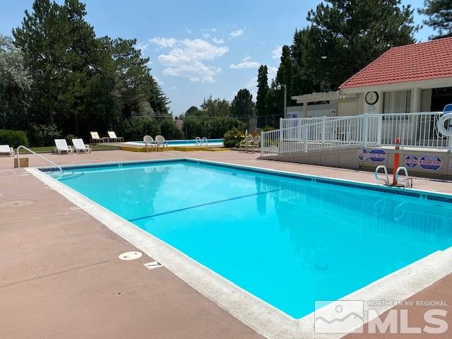 1207 Searchlite Court Reno, NV 89503 - Photo 4 of 17 a view of swimming pool with lawn chairs and plants