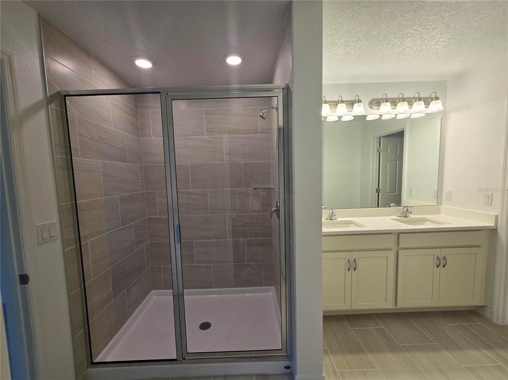 1147 Happy Frst Loop DeLand, FL 32720 - Photo 6 of 10 a bathroom with a shower sink and mirror