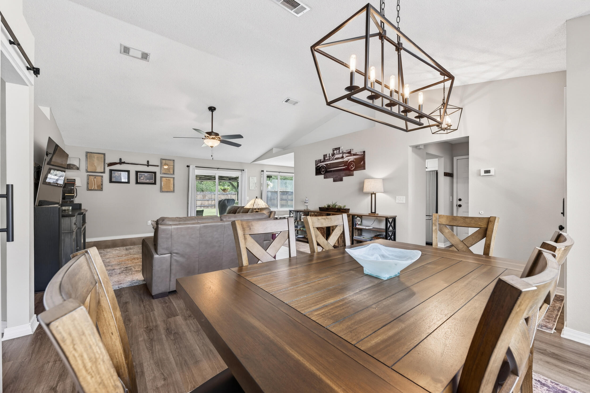 4331 Crosswind Drive Milton, FL 32583 - Photo 12 of 50 a view of a dining room with furniture a chandelier and wooden floor