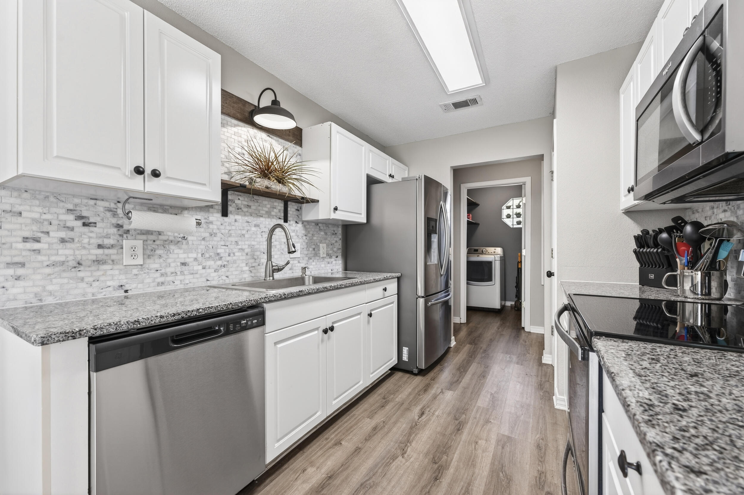 4331 Crosswind Drive Milton, FL 32583 - Photo 14 of 50 a kitchen with stainless steel appliances granite countertop a sink stove and refrigerator