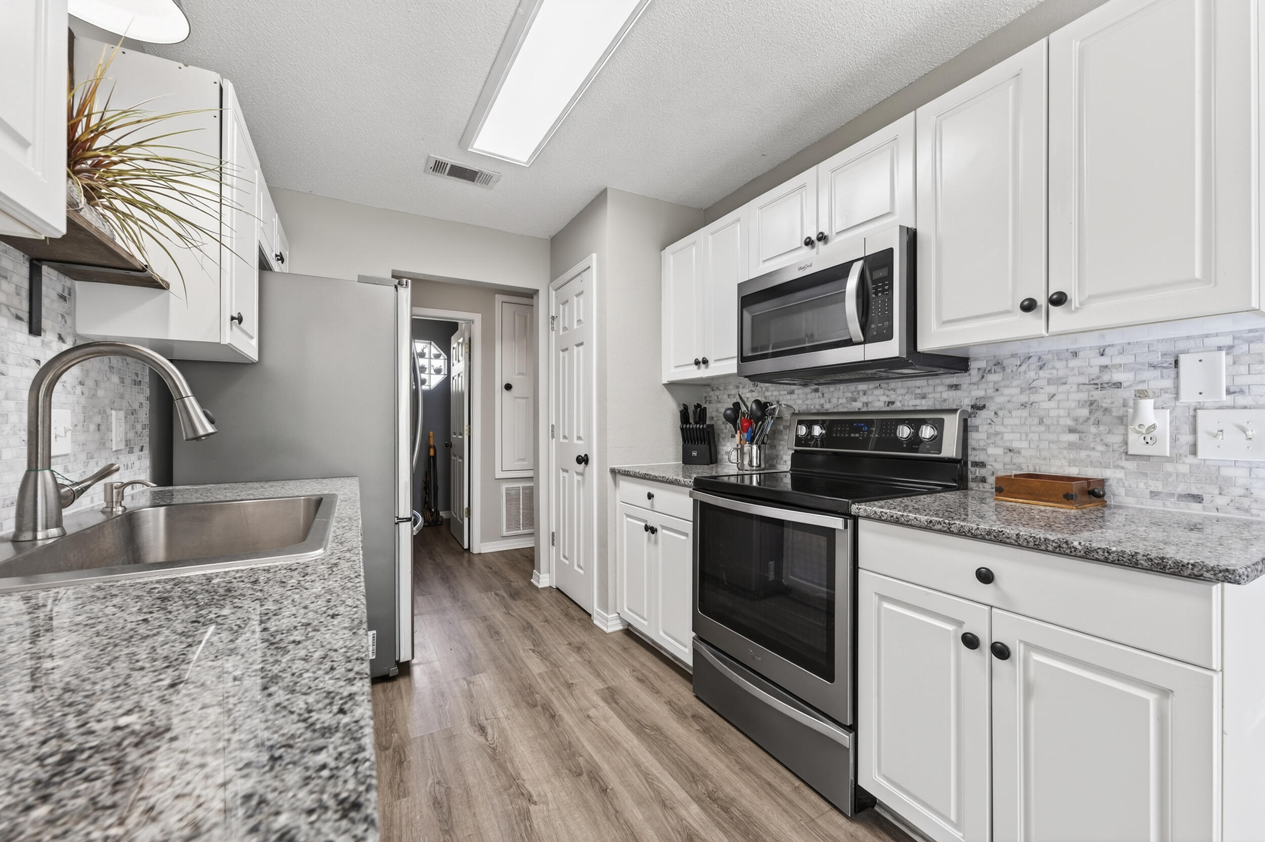 4331 Crosswind Drive Milton, FL 32583 - Photo 15 of 50 a kitchen with stainless steel appliances granite countertop a sink and a microwave