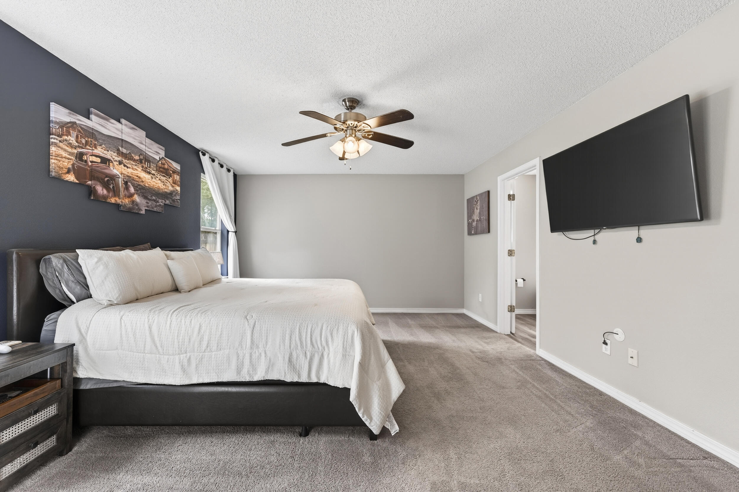 4331 Crosswind Drive Milton, FL 32583 - Photo 18 of 50 a bedroom with a bed and a flat screen tv