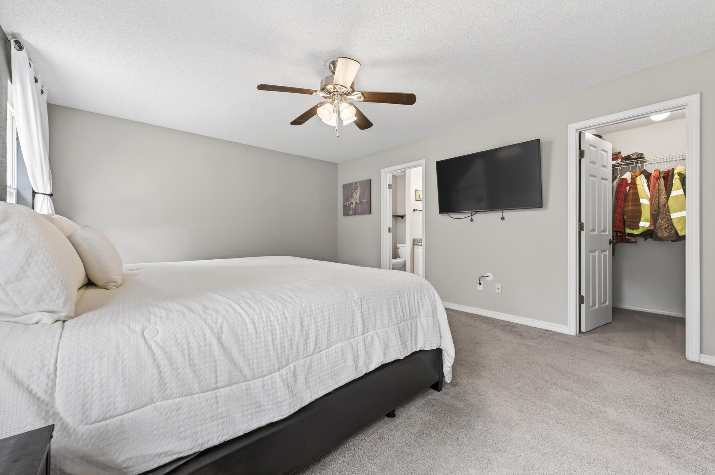 4331 Crosswind Drive Milton, FL 32583 - Photo 20 of 50 a bedroom with a large bed and a flat screen tv