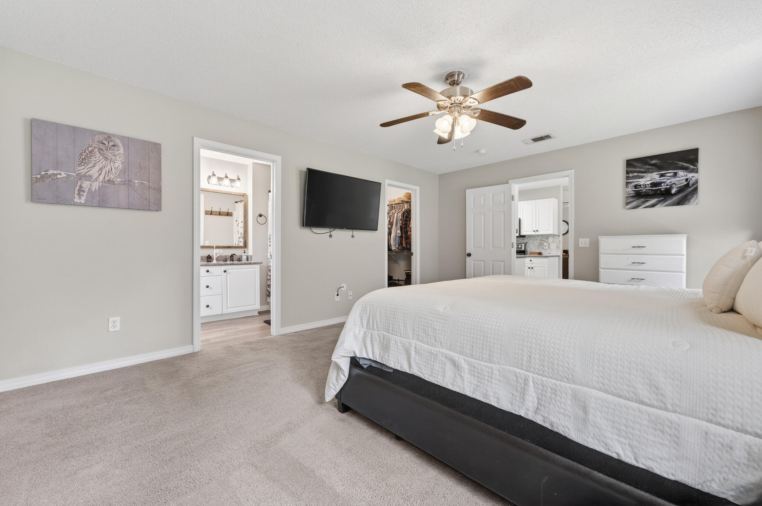 4331 Crosswind Drive Milton, FL 32583 - Photo 22 of 50 a spacious bedroom with a bed and a chandelier
