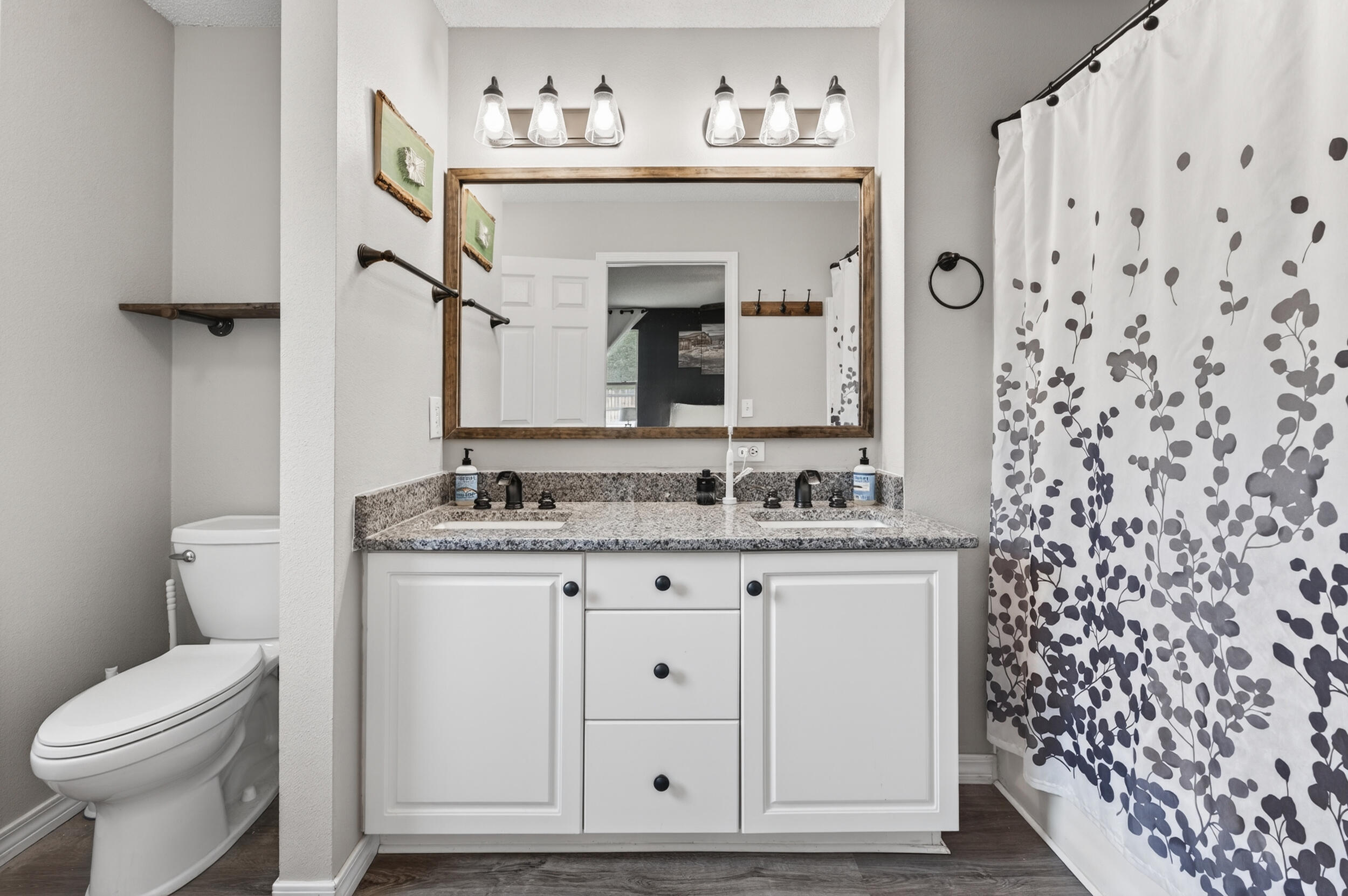 4331 Crosswind Drive Milton, FL 32583 - Photo 23 of 50 a bathroom with a granite countertop sink vanity mirror and toilet