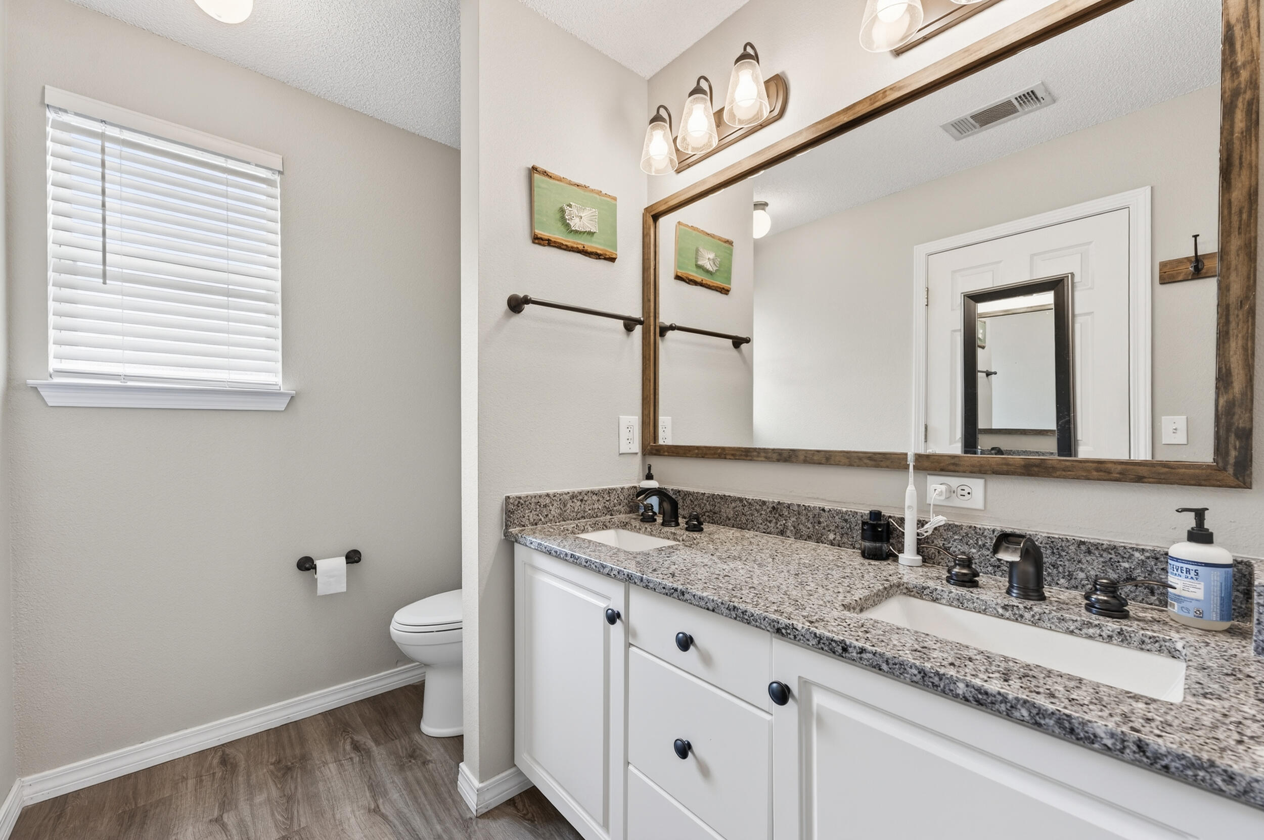4331 Crosswind Drive Milton, FL 32583 - Photo 24 of 50 a bathroom with a granite countertop sink and a mirror
