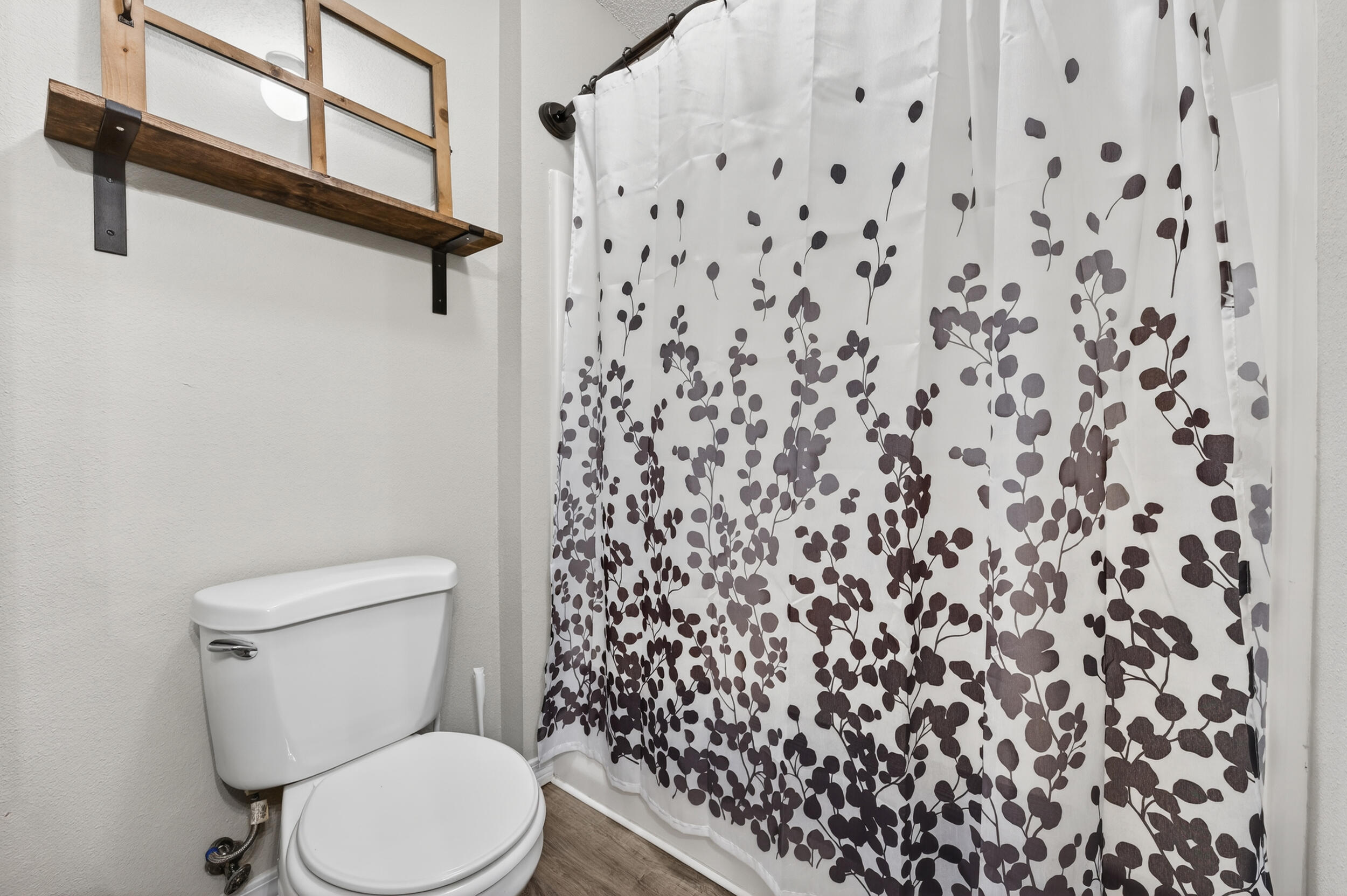 4331 Crosswind Drive Milton, FL 32583 - Photo 34 of 50 a white toilet sitting next to a shower curtain