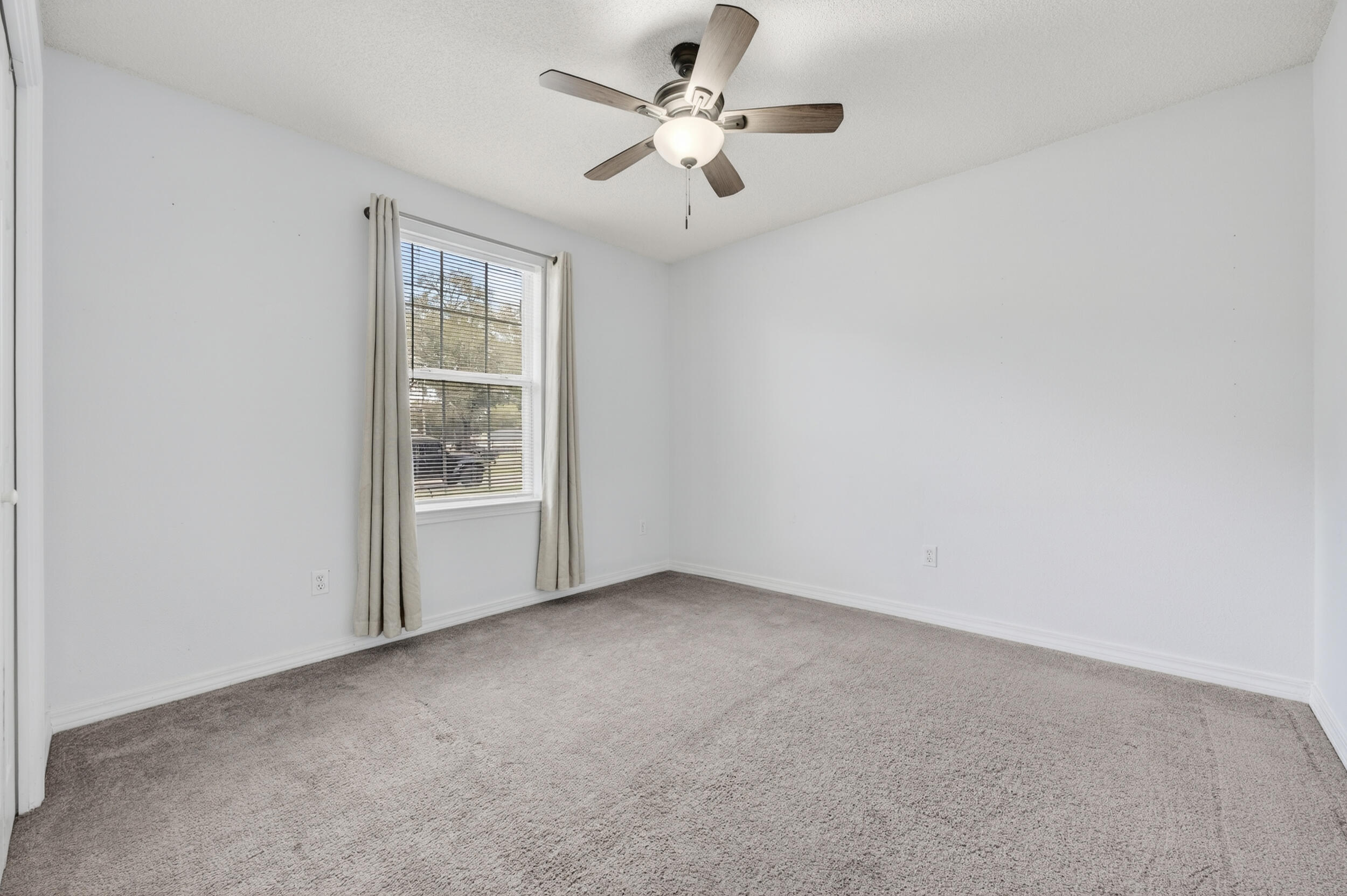 4331 Crosswind Drive Milton, FL 32583 - Photo 35 of 50 an empty room with windows and ceiling fan
