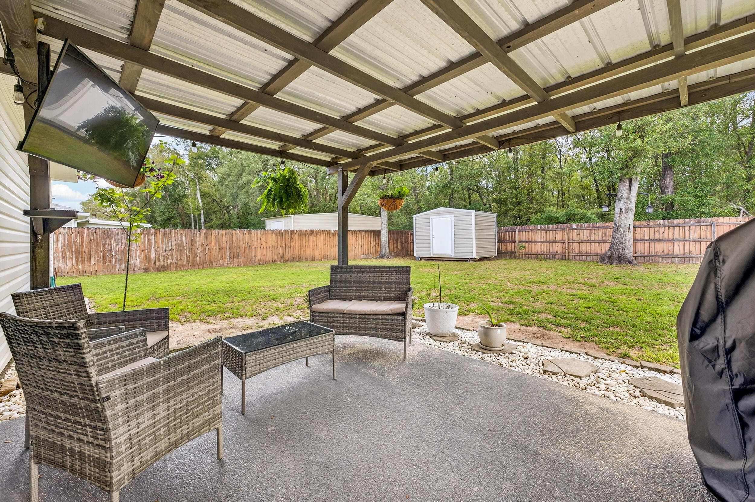 4331 Crosswind Drive Milton, FL 32583 - Photo 37 of 50 a view of a patio with a table chairs and a swimming pool