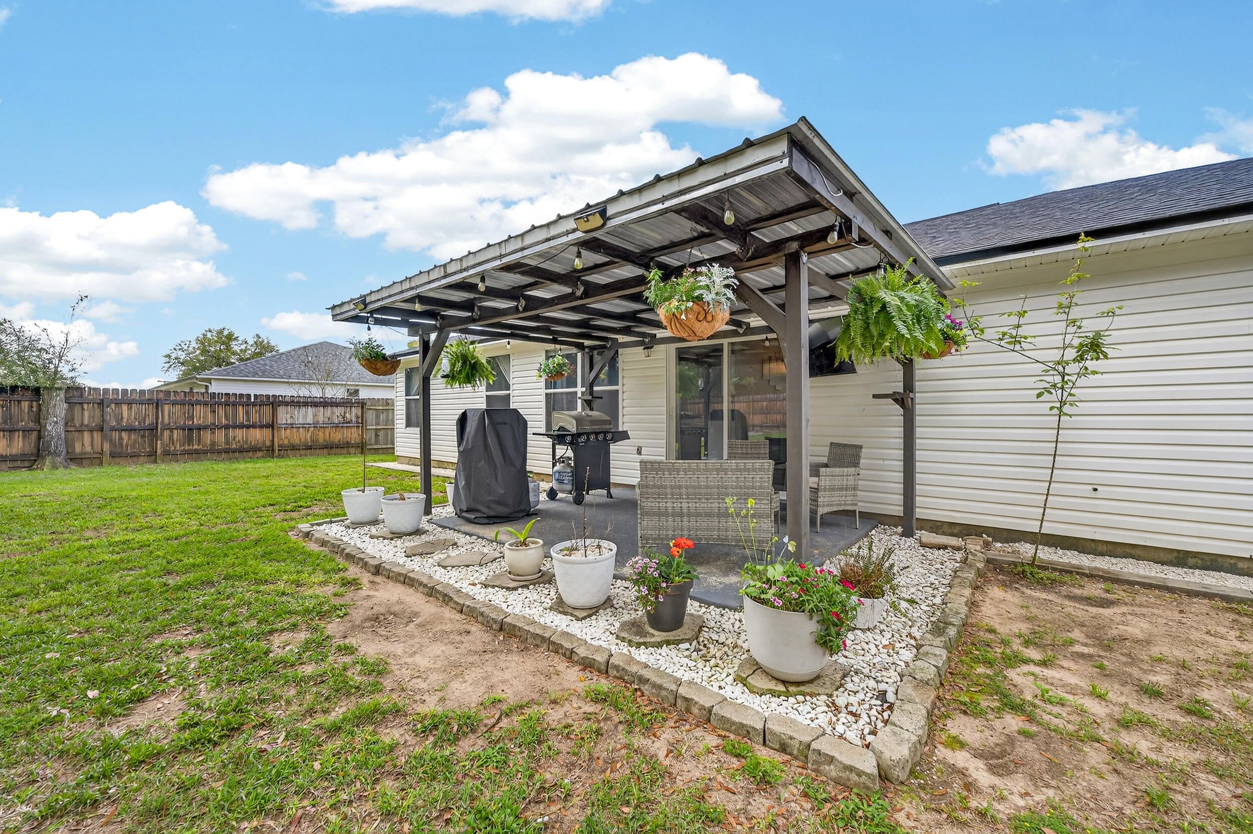 4331 Crosswind Drive Milton, FL 32583 - Photo 39 of 50 a front view of a house with garden