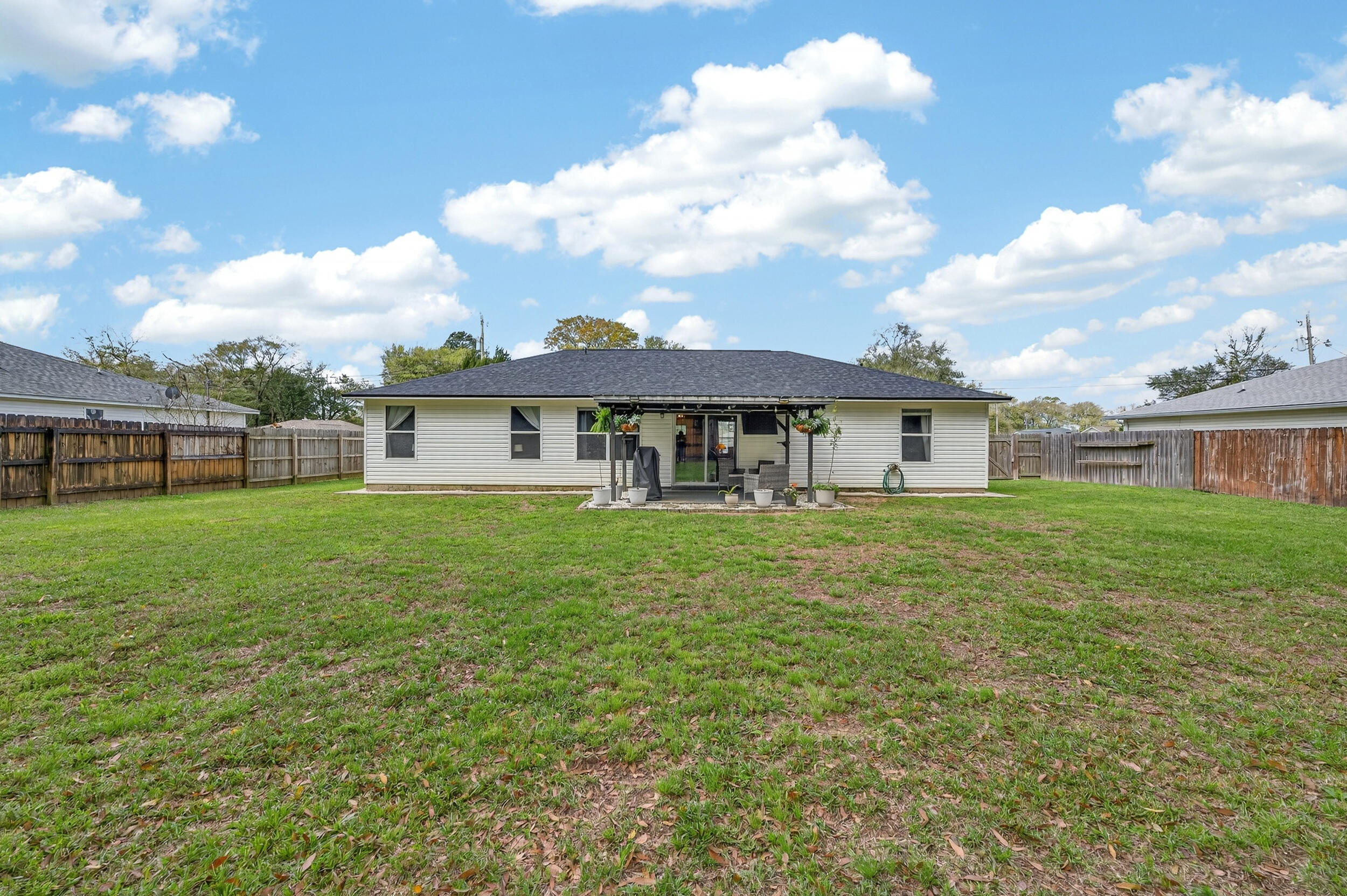 4331 Crosswind Drive Milton, FL 32583 - Photo 43 of 50 a front view of a house with a garden