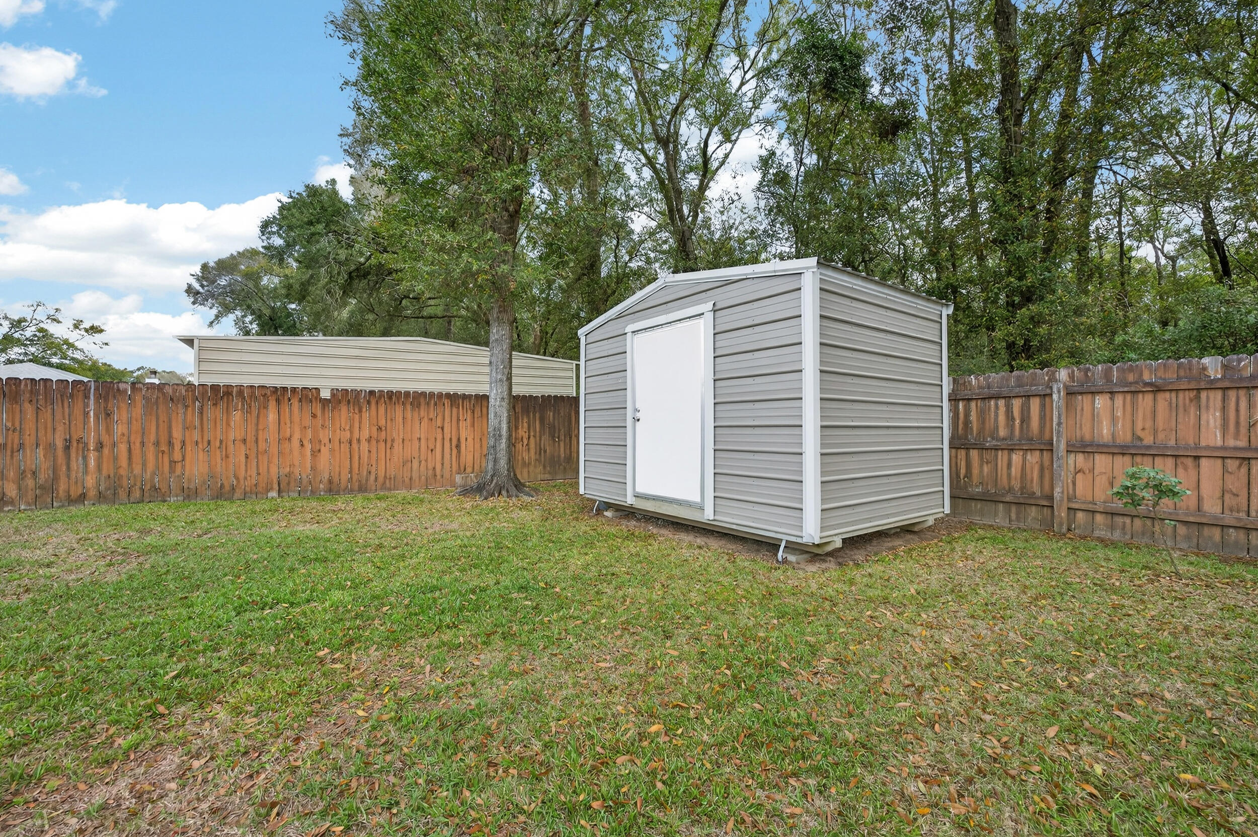 4331 Crosswind Drive Milton, FL 32583 - Photo 44 of 50 a view of a backyard with a garden