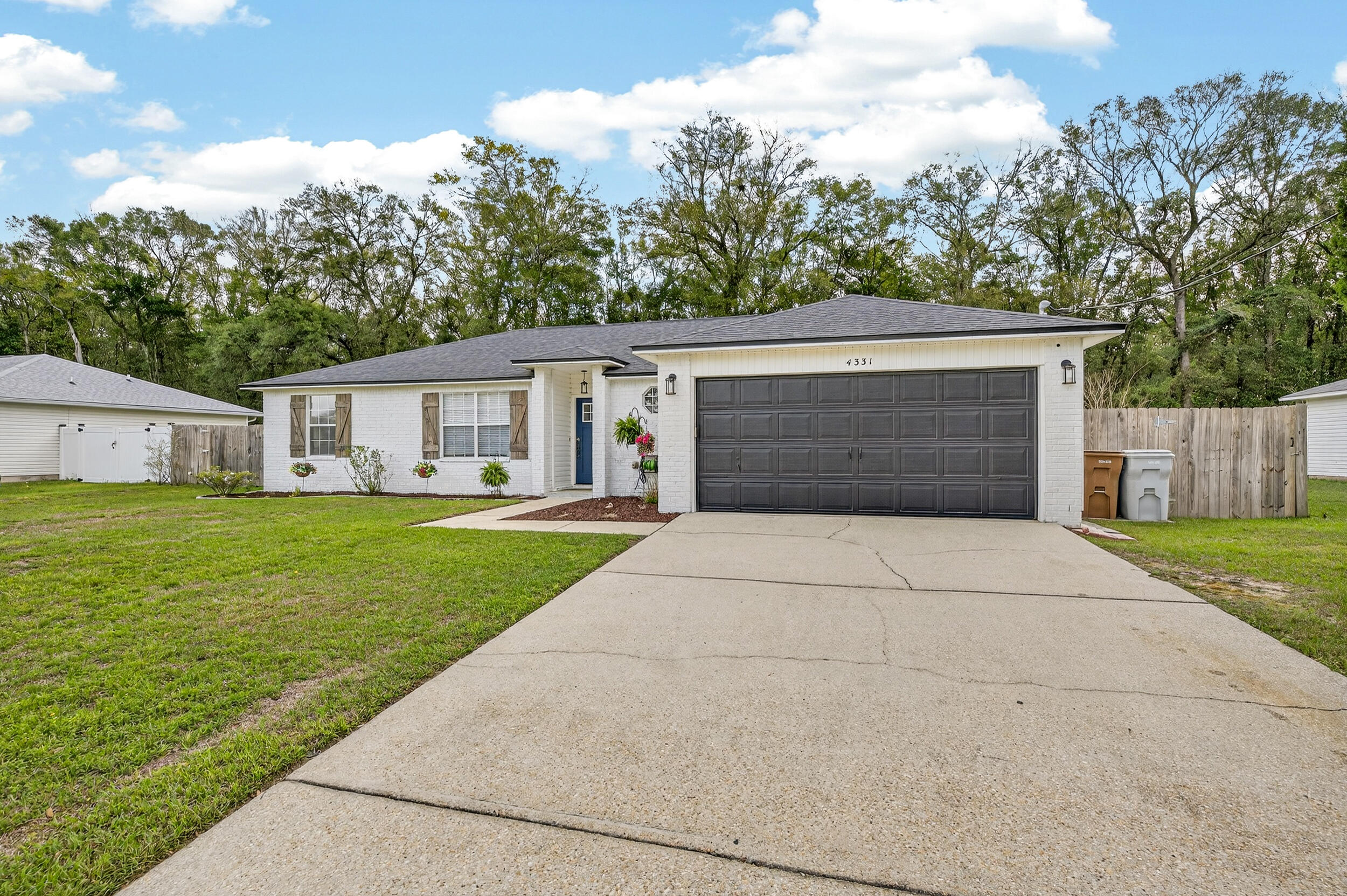 4331 Crosswind Drive Milton, FL 32583 - Photo 47 of 50 a front view of house with yard and trees in the background