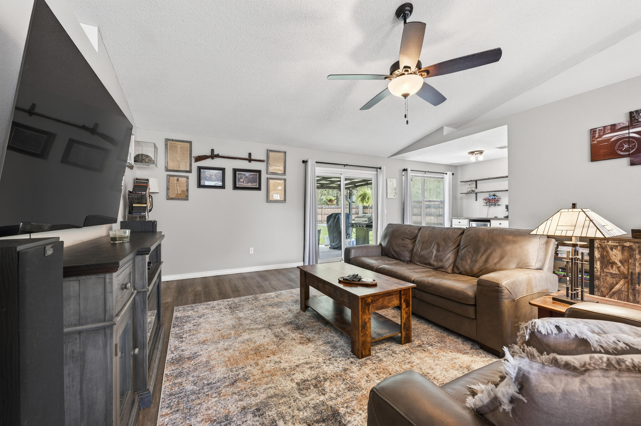 4331 Crosswind Drive Milton, FL 32583 - Photo 5 of 50 a living room with furniture and a flat screen tv
