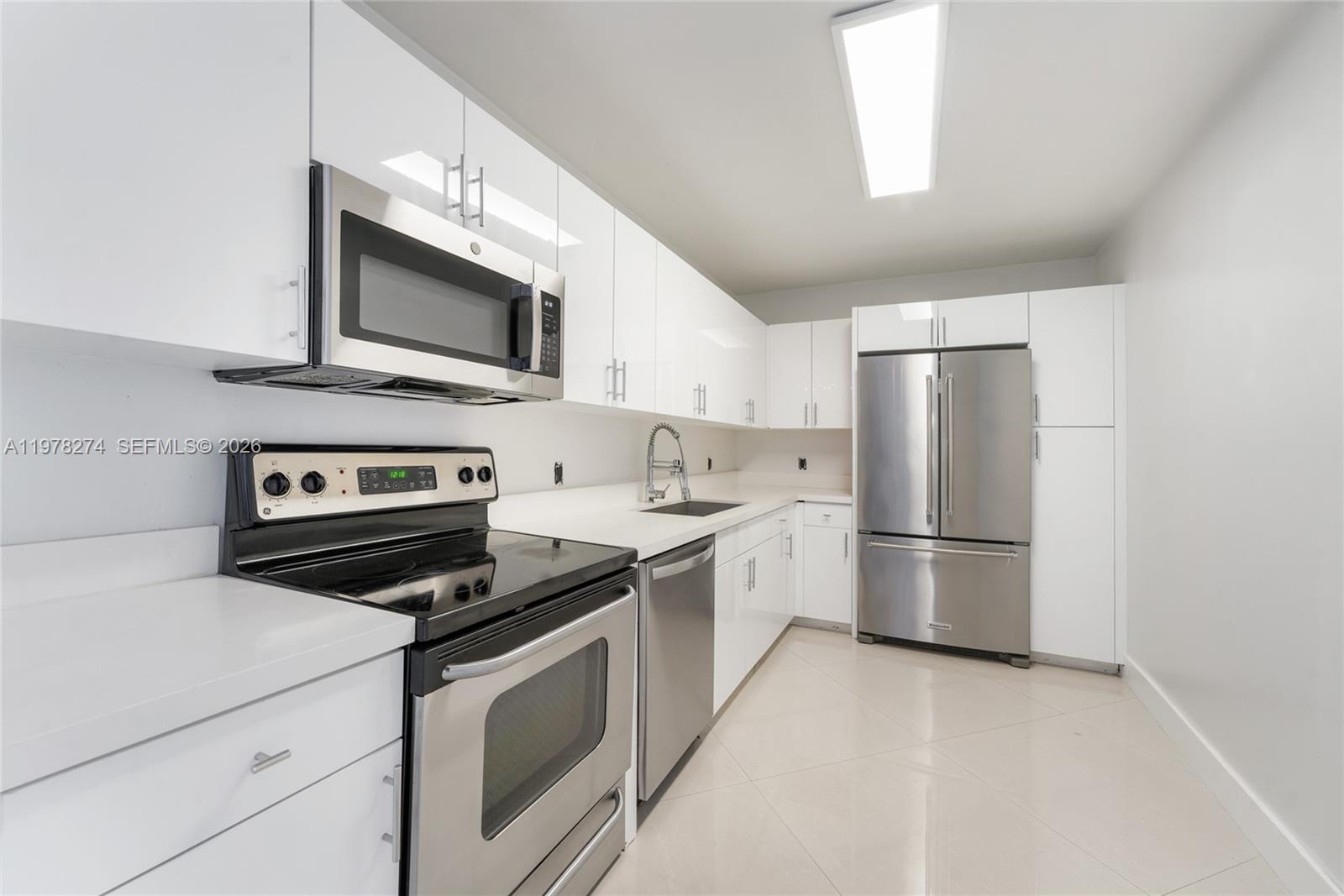 a kitchen with a refrigerator stove and microwave