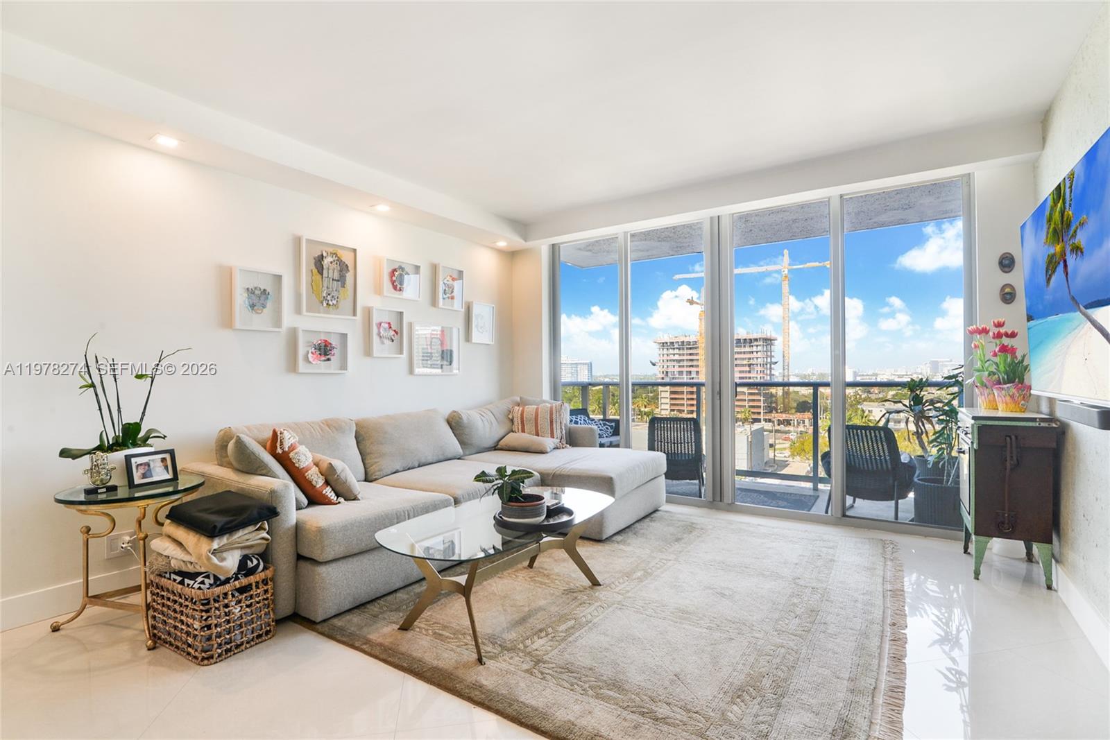 401 69th Street, Unit 913 Miami Beach, FL 33141 - Photo 4 of 26 a living room with furniture and a floor to ceiling window